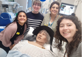 group of people around a medical dummy